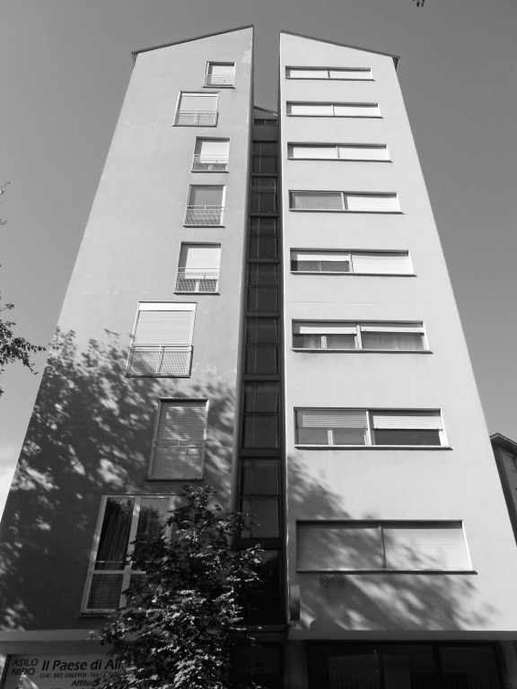 La facciata su via Caterina da Forlì con in evidenza l'ampia fenditura centrale che divide longitudinalmente in due l'edificio